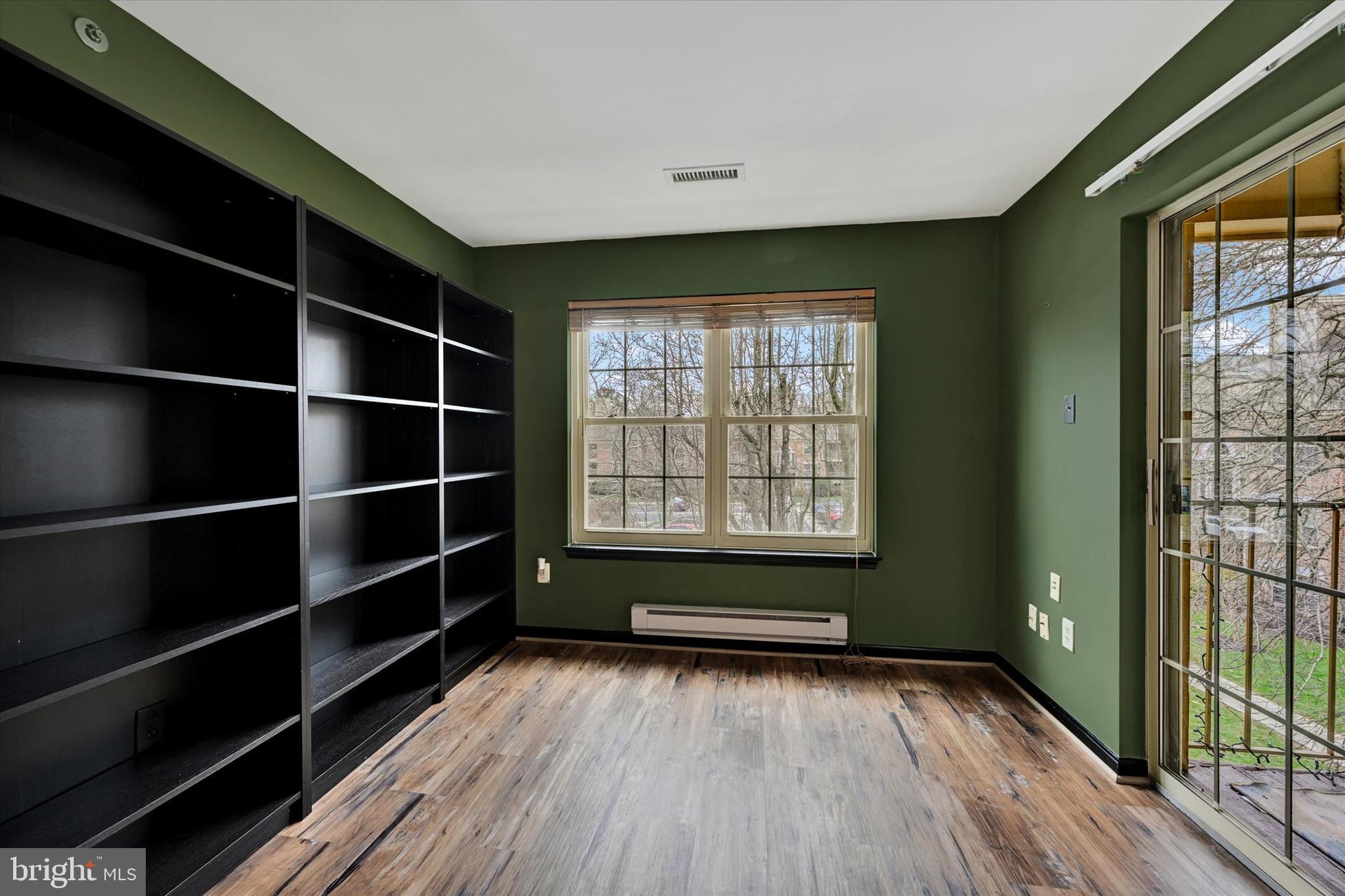 22 Rain Flower Path, Unit 301 Sparks Glencoe, MD 21152 - Photo 8 of 21 a view of an empty room with wooden floor and a window