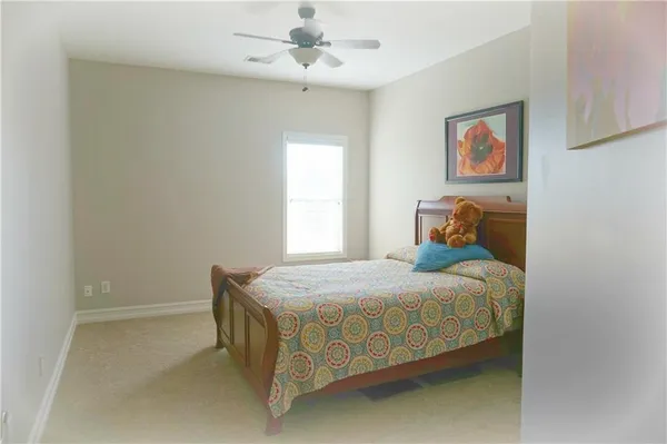 a bedroom with a bed and window