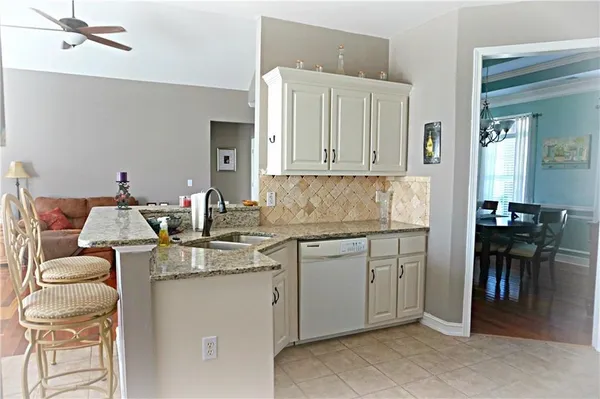 a kitchen with a sink cabinets and wooden floor
