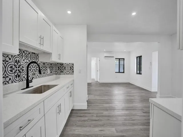 a kitchen with sink and cabinets