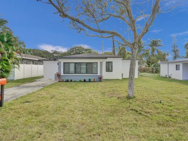 a house with huge green field in front of it
