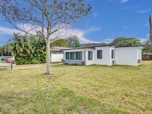 a backyard of a house with yard and tree