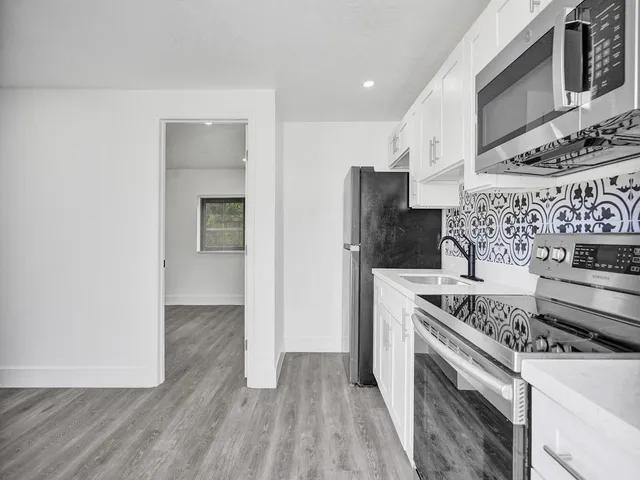 a kitchen with a stove and a refrigerator