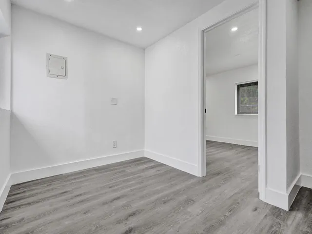 a view of a room with wooden floor