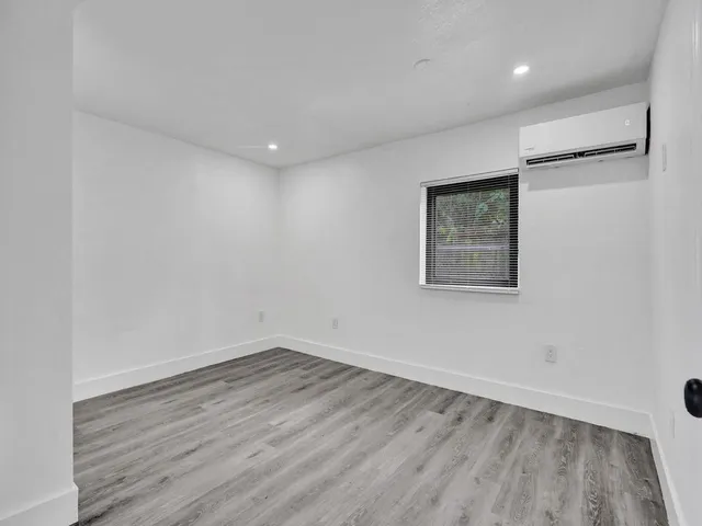 a view of a room with wooden floor and window