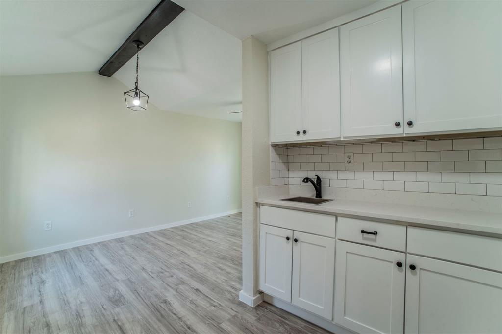 5914 Victor Street Dallas, TX 75214 - Photo 19 of 32 a kitchen with white cabinets and sink