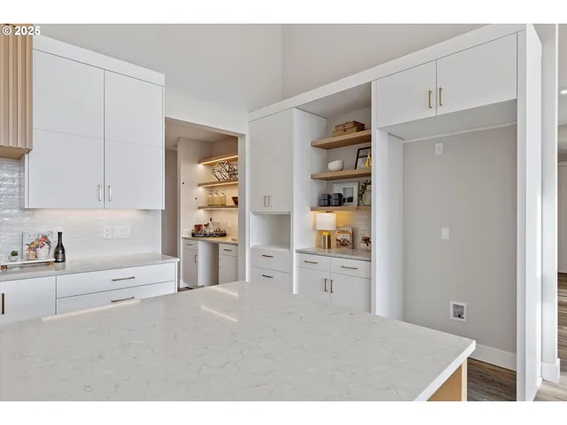 a open kitchen with cabinets and wooden floor