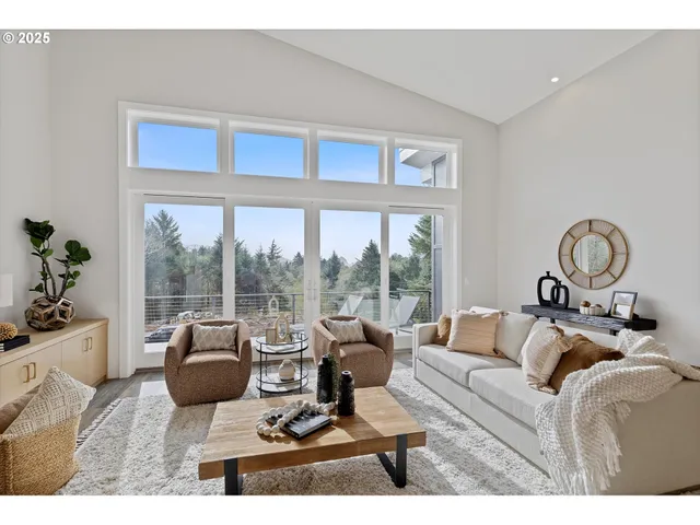a living room with furniture a large window and a table