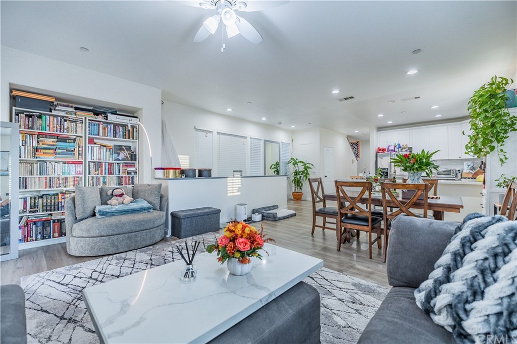 a living room with furniture and a kitchen view