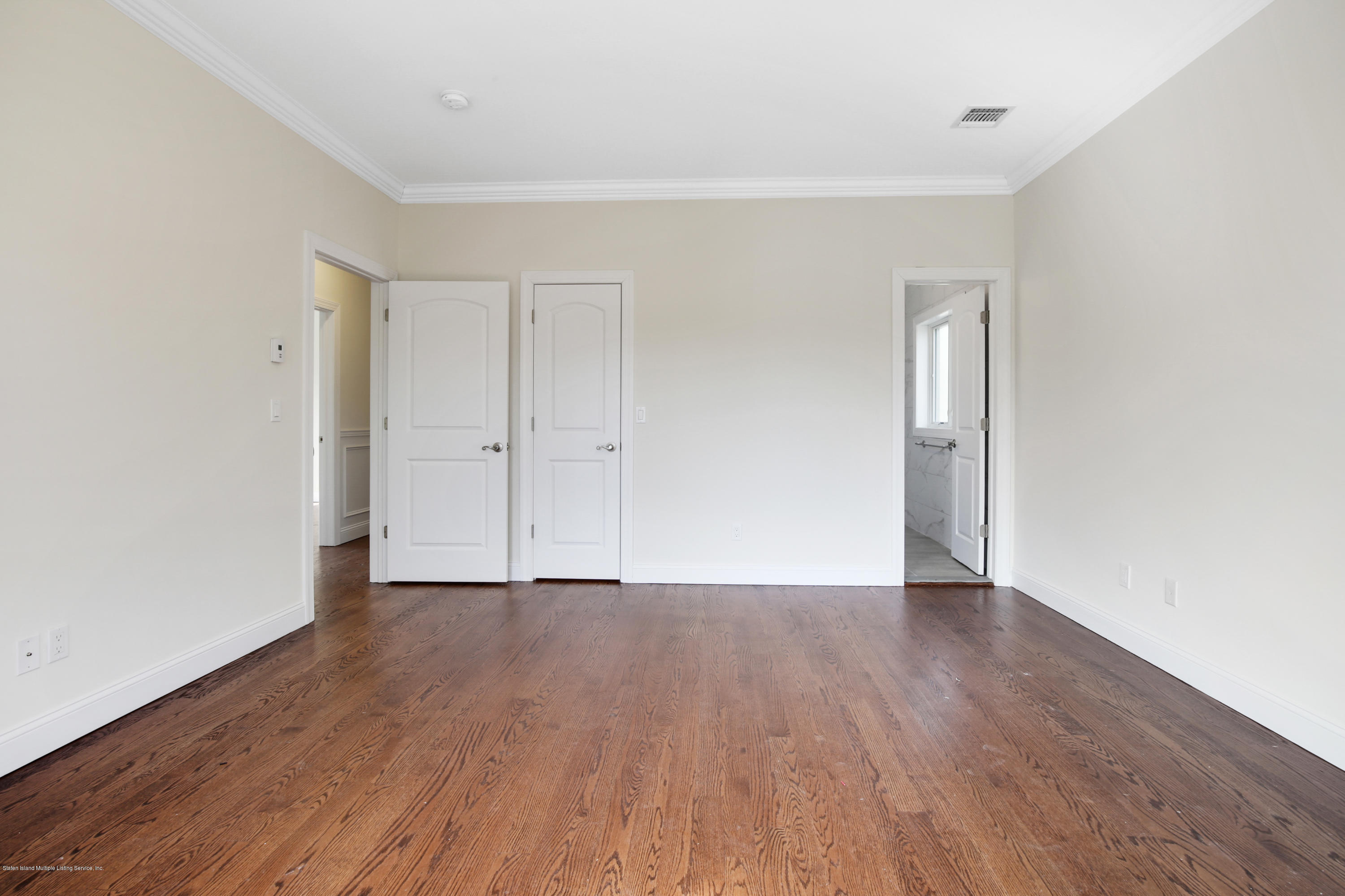 232 8 Street Staten Island, NY 10306 - Photo 11 of 25 a view of an empty room with wooden floor