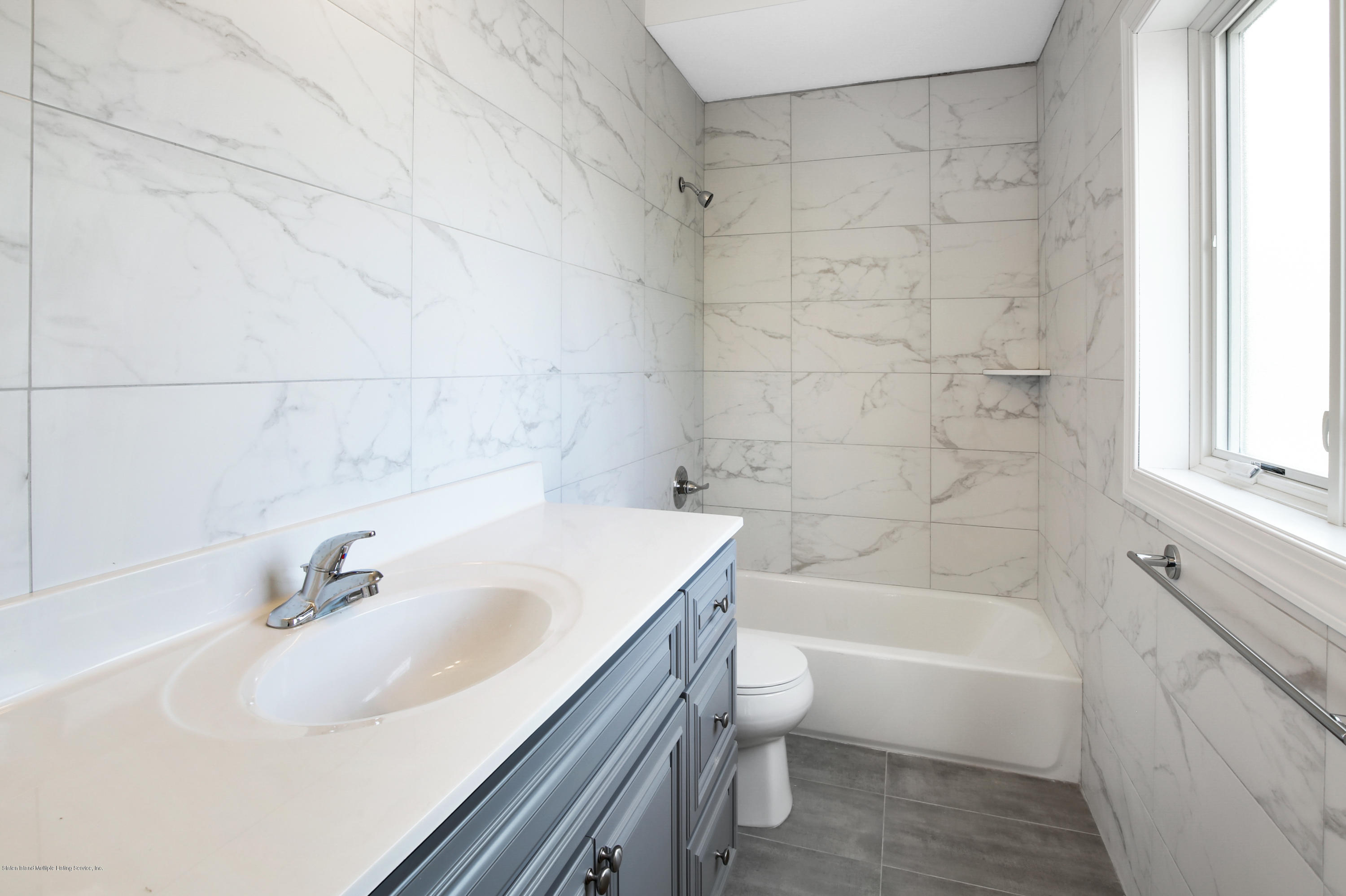 232 8 Street Staten Island, NY 10306 - Photo 12 of 25 a bathroom with a sink a toilet and bathtub