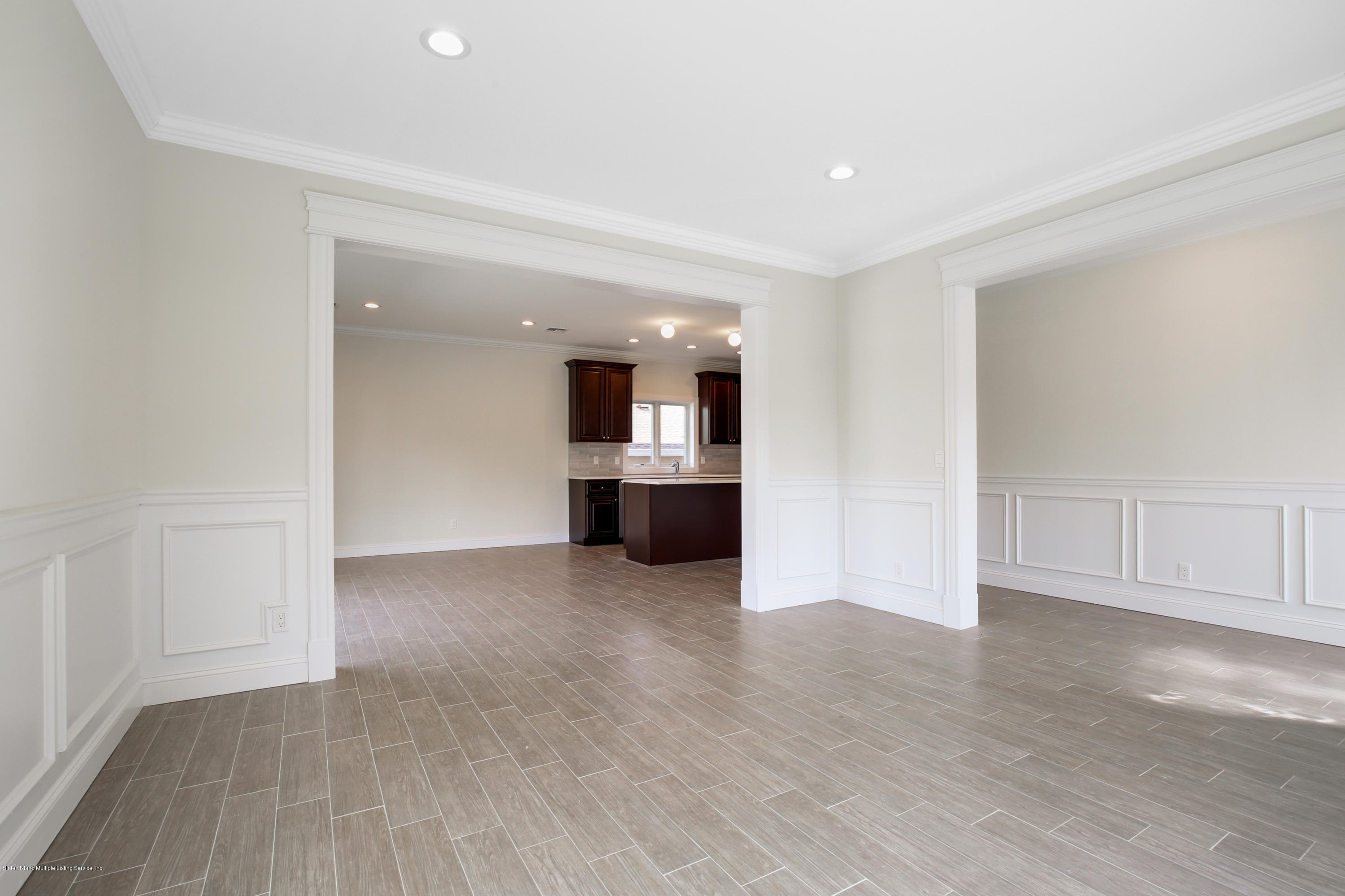 232 8 Street Staten Island, NY 10306 - Photo 13 of 25 an empty room with kitchen and natural light