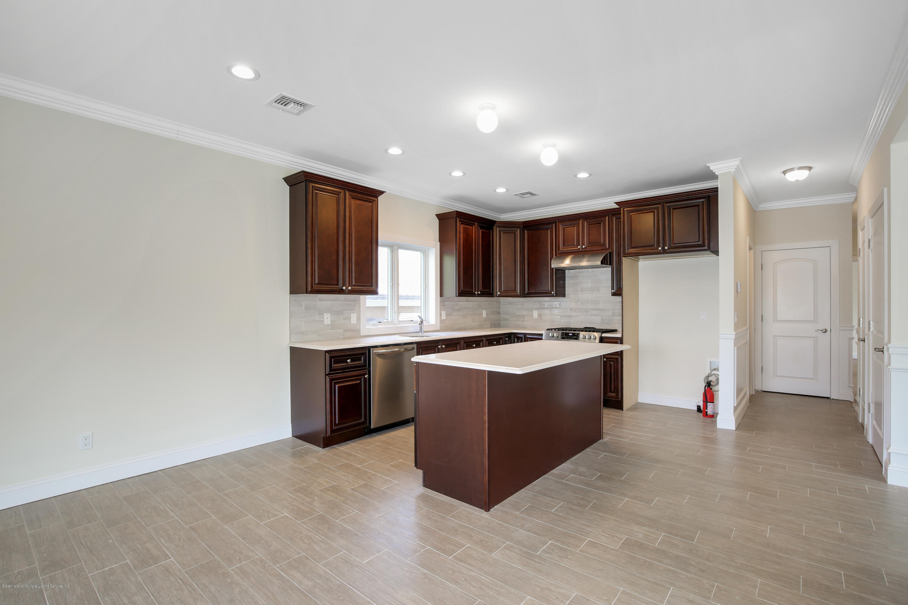232 8 Street Staten Island, NY 10306 - Photo 14 of 25 a large kitchen with stainless steel appliances granite countertop a large counter top and a stove top oven
