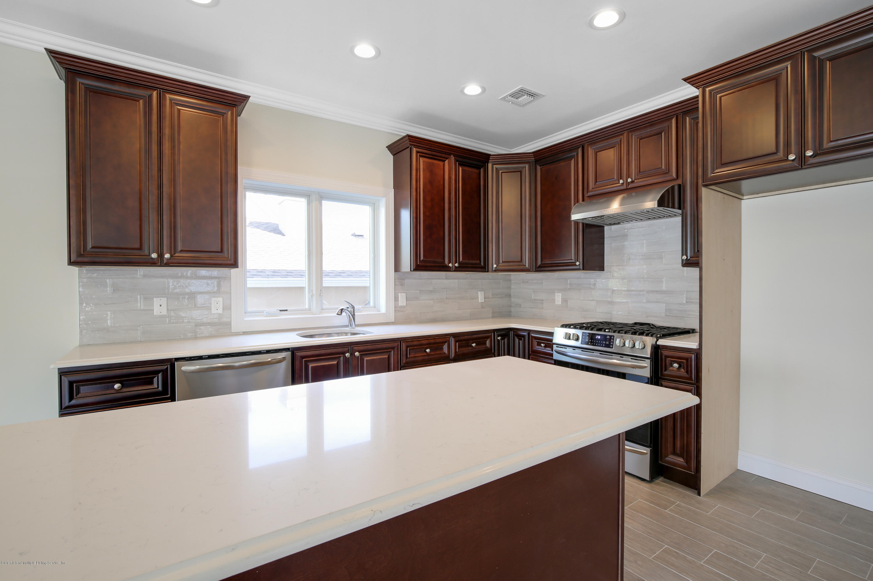 232 8 Street Staten Island, NY 10306 - Photo 15 of 25 a kitchen with stainless steel appliances granite countertop a sink stove and cabinets