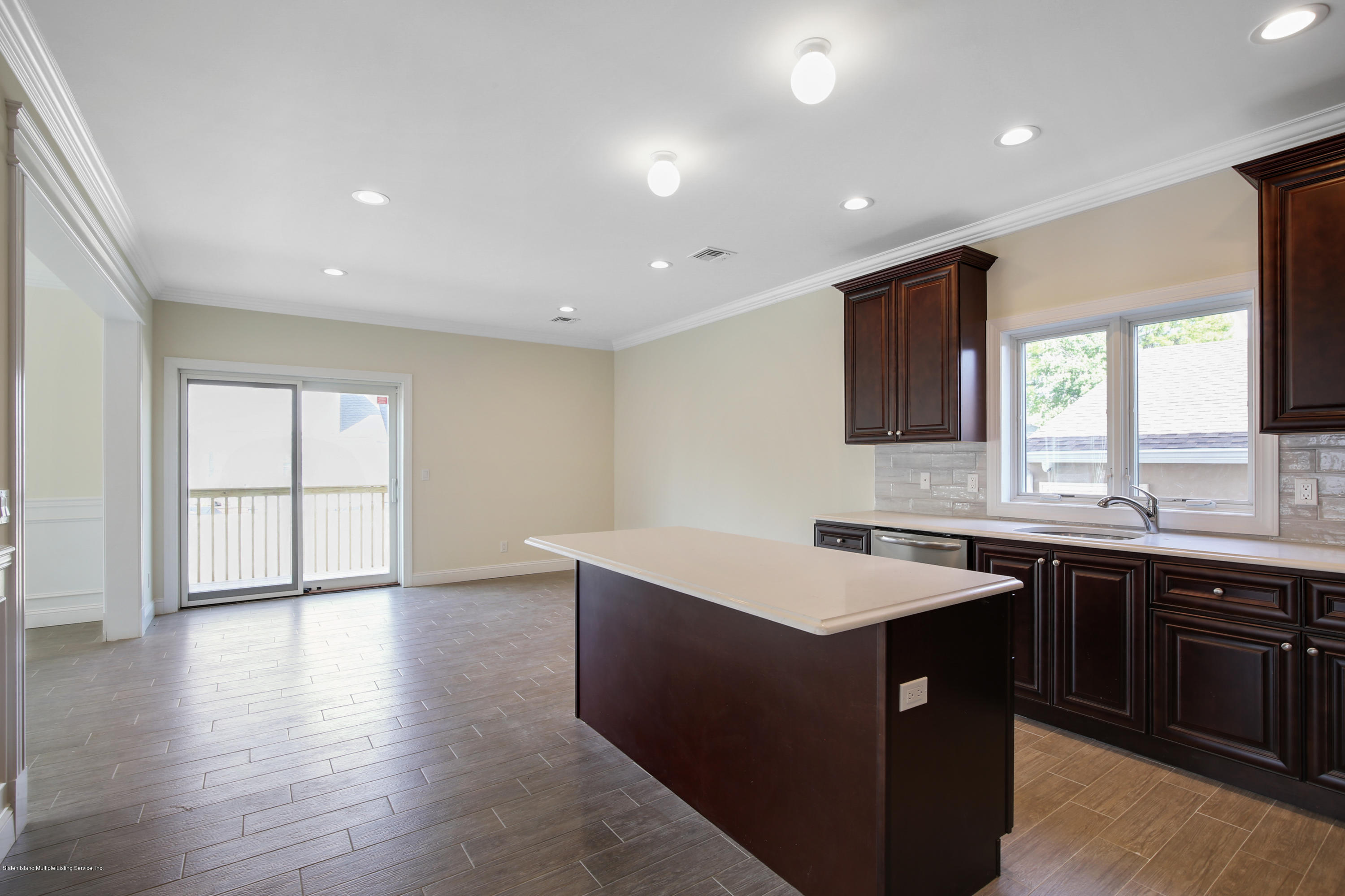 232 8 Street Staten Island, NY 10306 - Photo 16 of 25 a kitchen with counter top space sink and center island