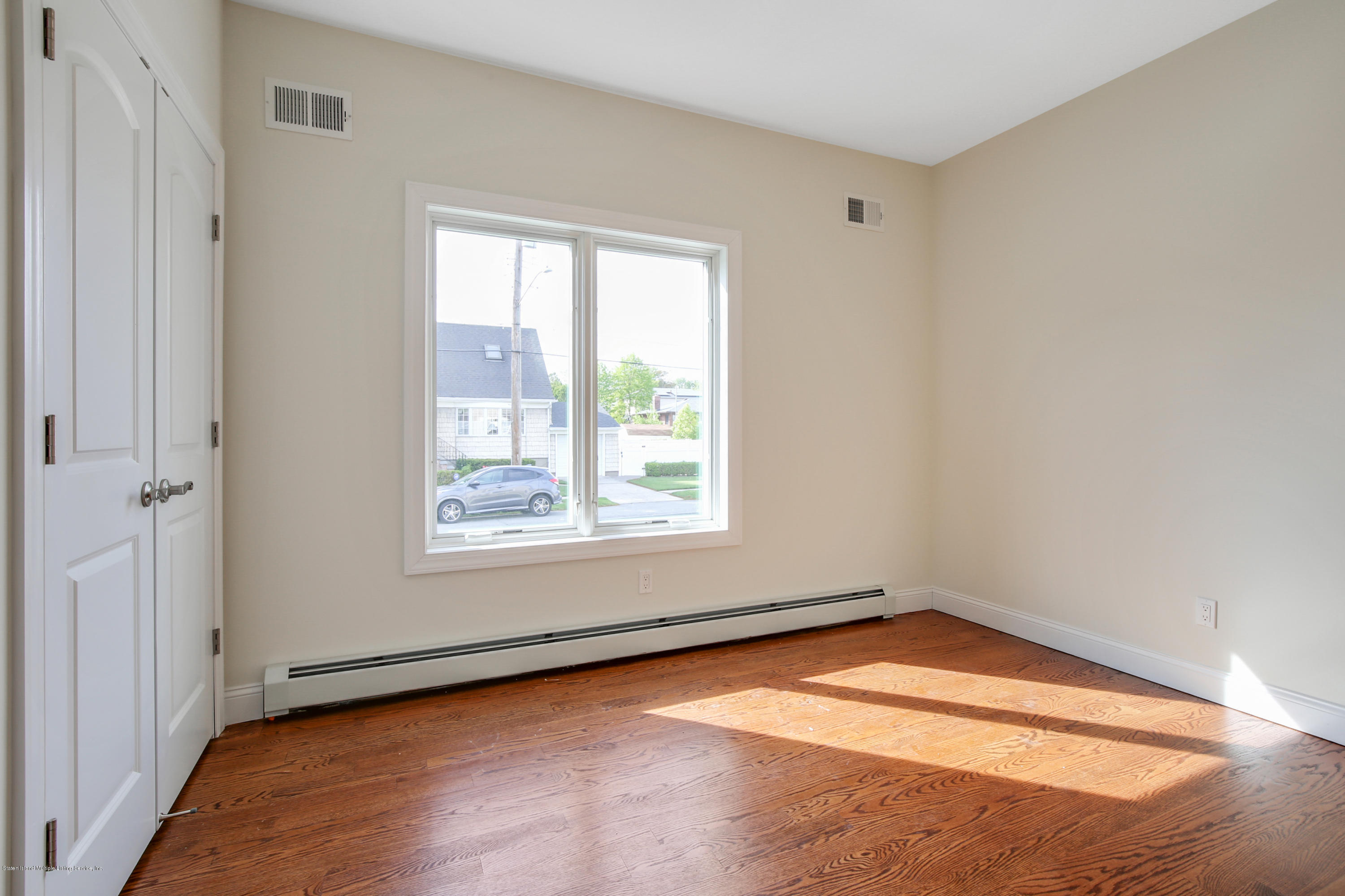 232 8 Street Staten Island, NY 10306 - Photo 19 of 25 an empty room with a window