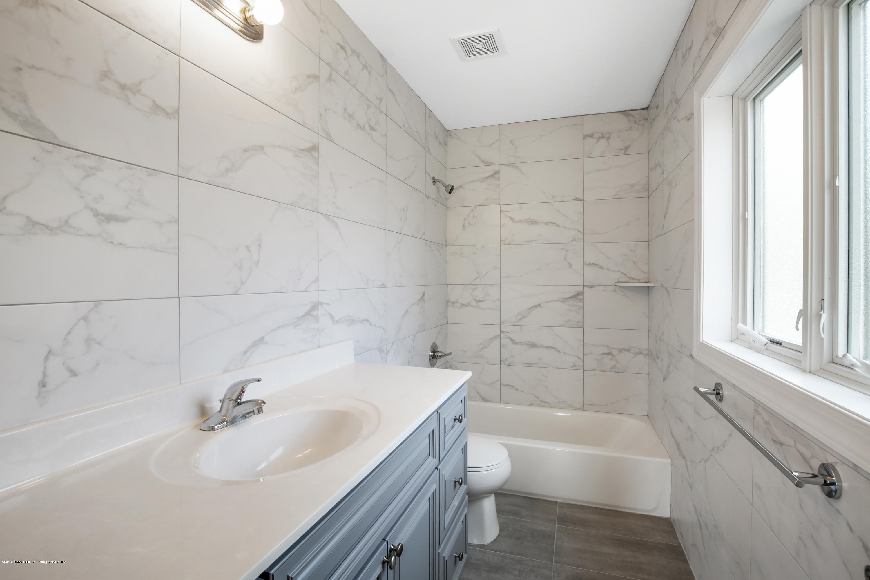 232 8 Street Staten Island, NY 10306 - Photo 22 of 25 a bathroom with a sink toilet bathtub and vanity