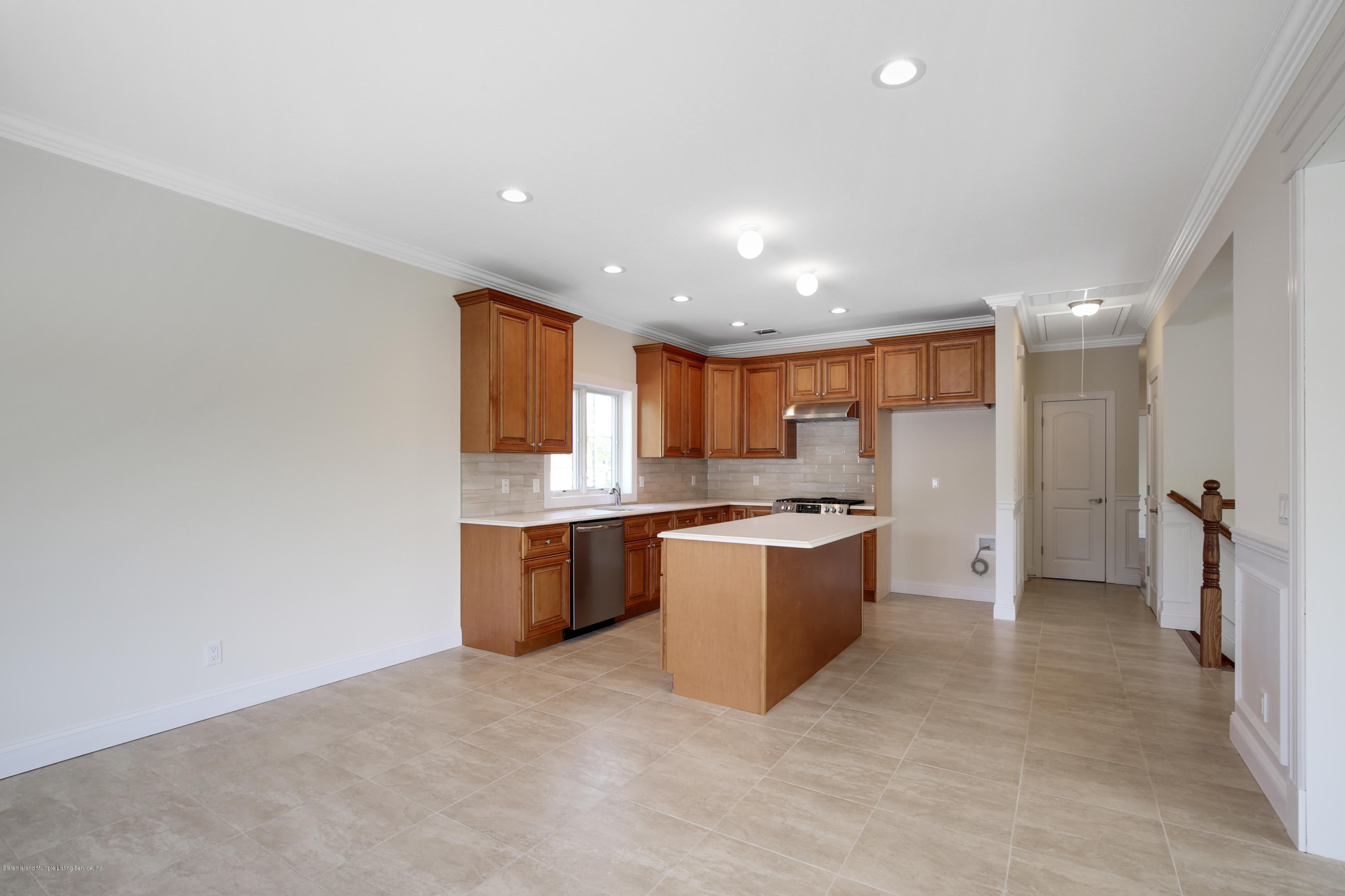 232 8 Street Staten Island, NY 10306 - Photo 5 of 25 a large kitchen with a refrigerator and a stove top oven