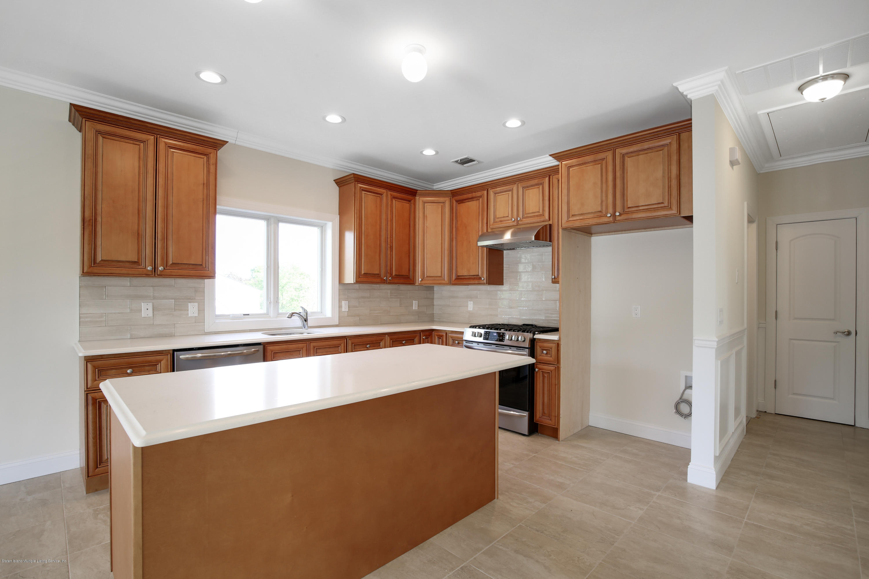 232 8 Street Staten Island, NY 10306 - Photo 6 of 25 a kitchen with stainless steel appliances granite countertop a sink a stove a refrigerator and cabinets