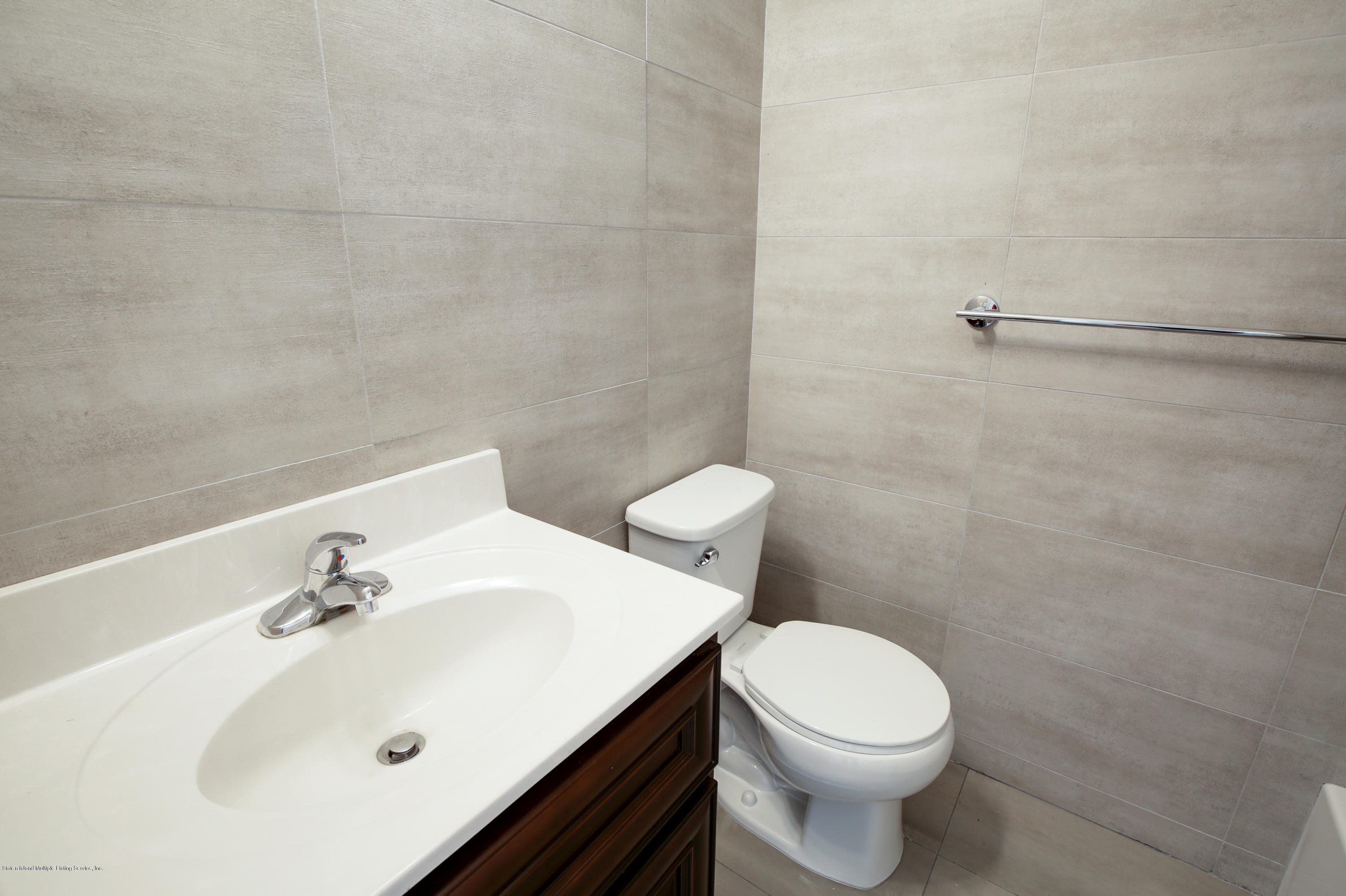 232 8 Street Staten Island, NY 10306 - Photo 7 of 25 a white toilet sitting next to a white sink