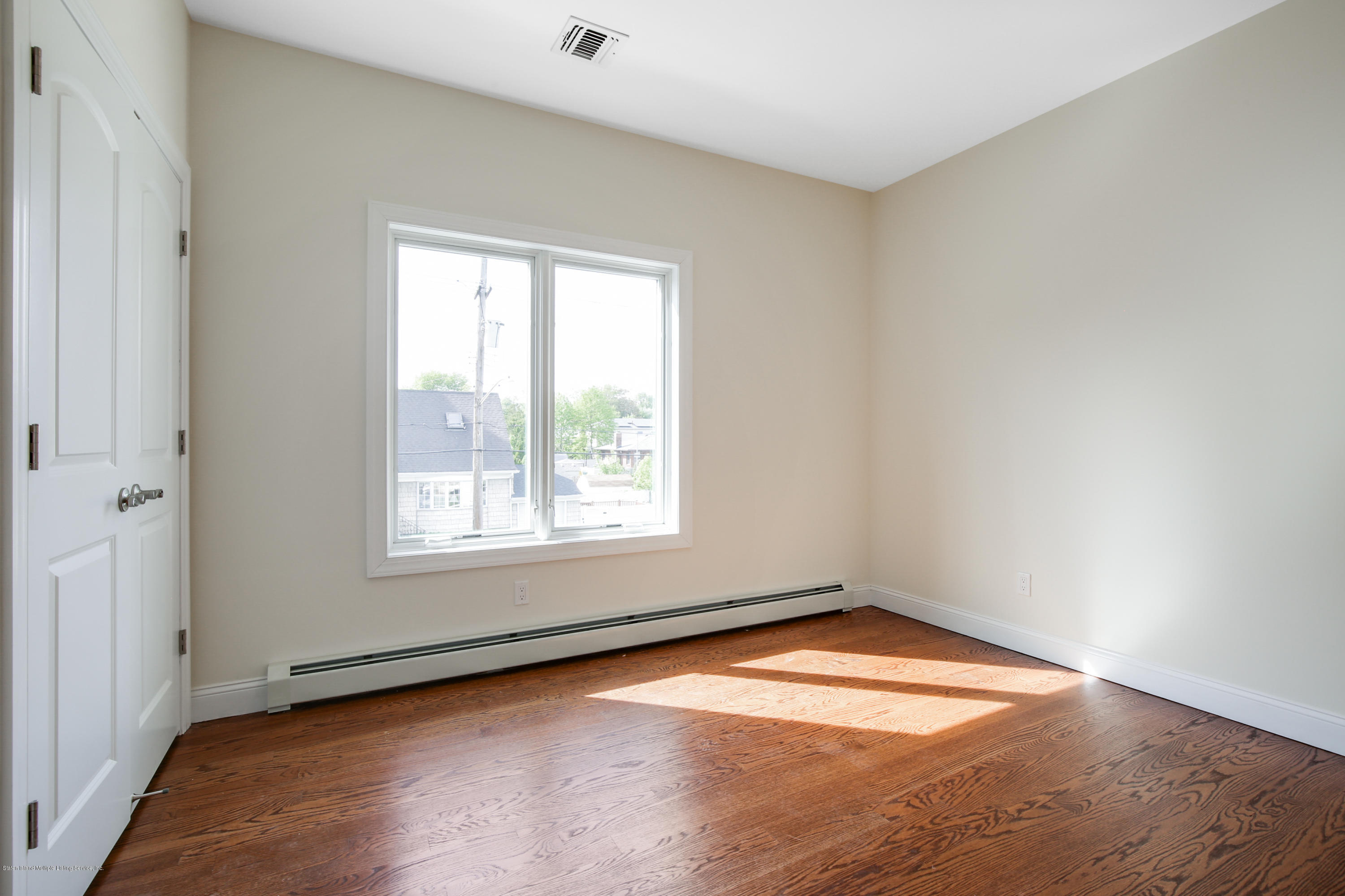 232 8 Street Staten Island, NY 10306 - Photo 8 of 25 an empty room with a window