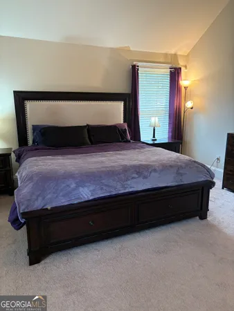 a bedroom with a bed and window