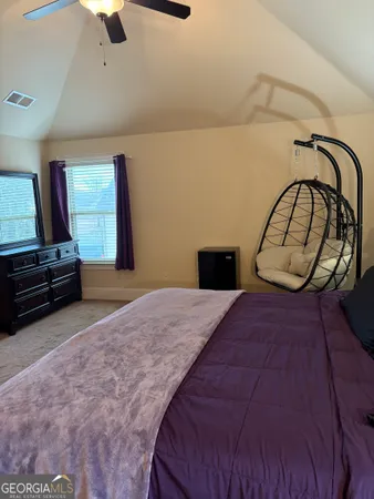 a bedroom with a bed and dresser with mirror