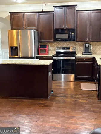 a kitchen with stainless steel appliances wooden cabinets and a sink