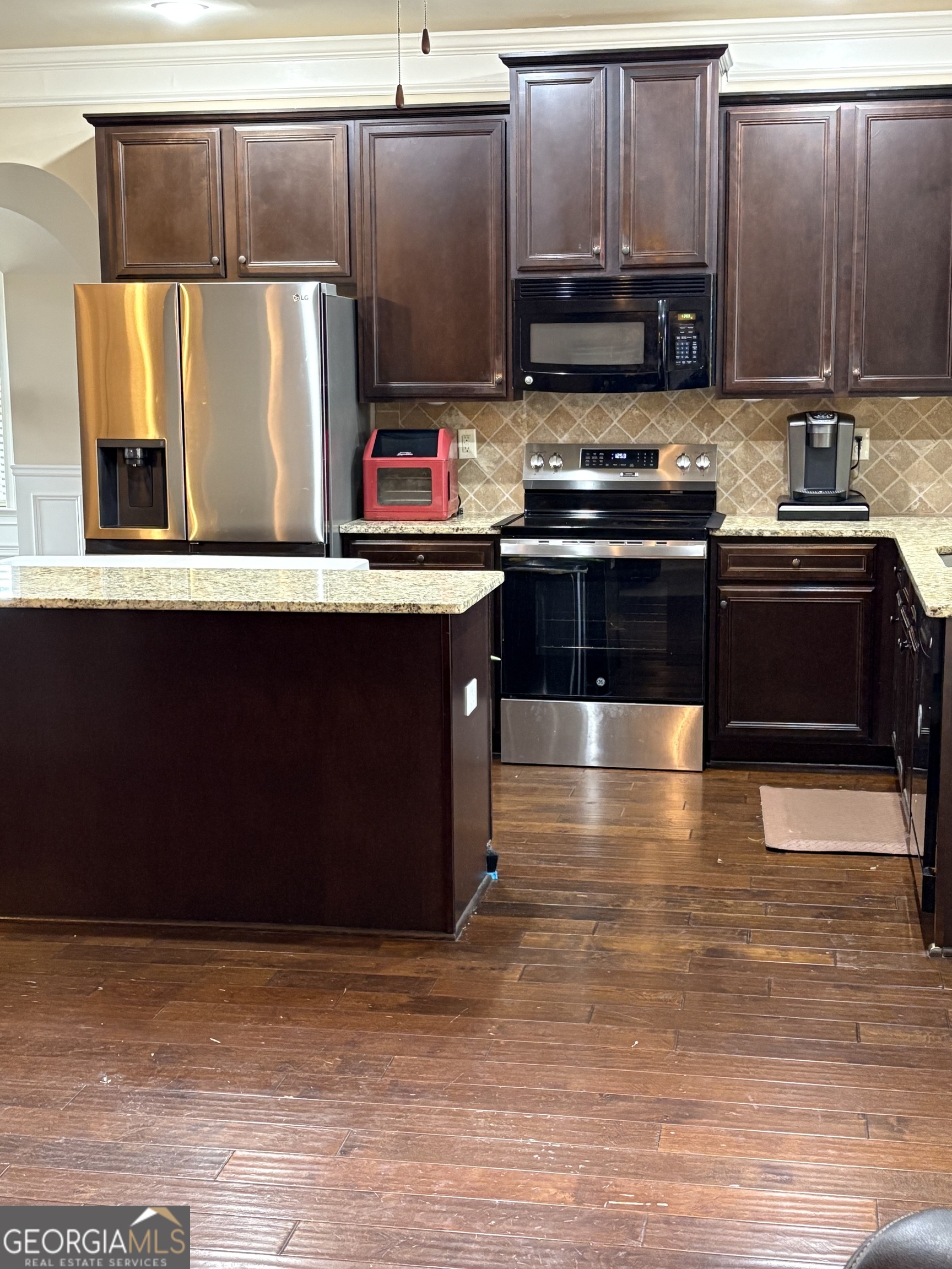 208 Deodar Lane Hampton, GA 30228 - Photo 6 of 28 a kitchen with stainless steel appliances wooden cabinets and a sink