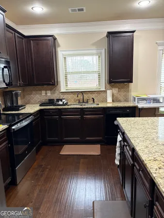 a kitchen with wooden cabinets and sink