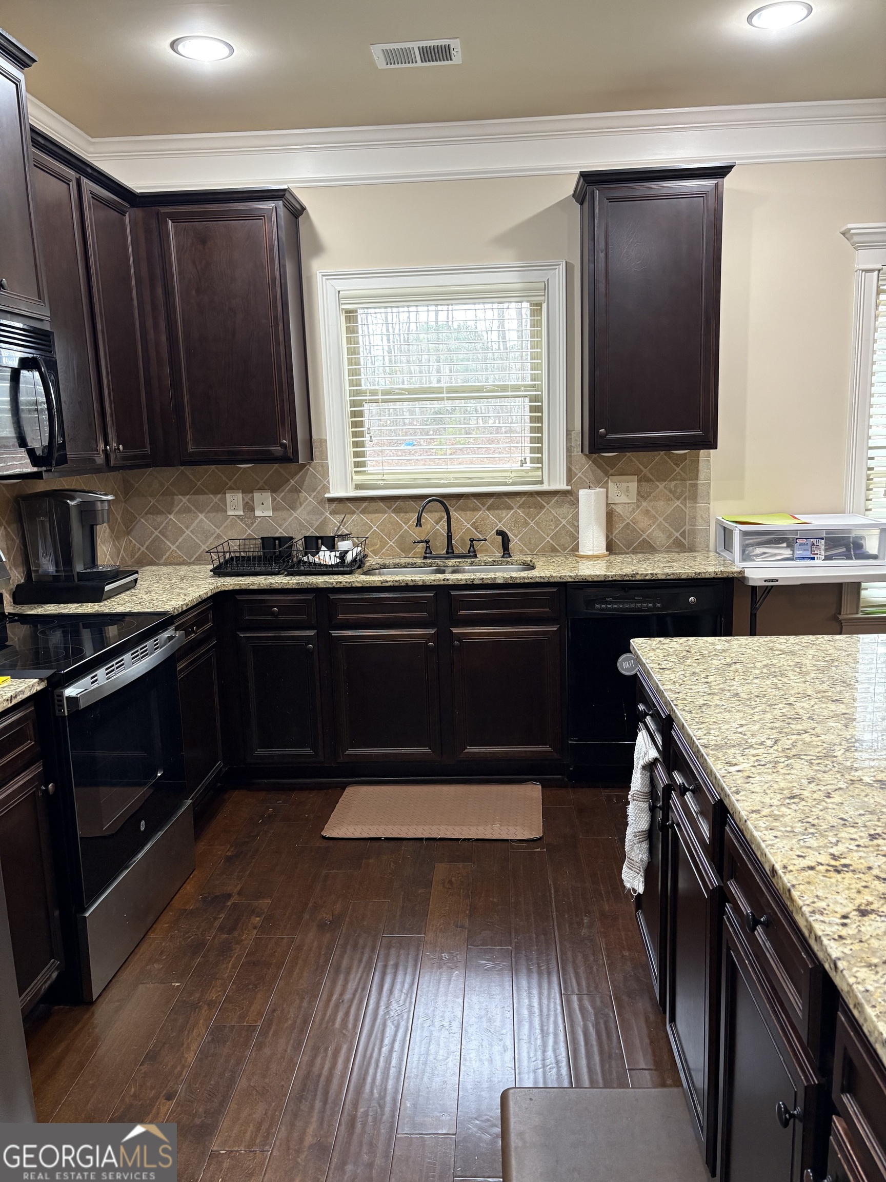 208 Deodar Lane Hampton, GA 30228 - Photo 7 of 28 a kitchen with wooden cabinets and sink
