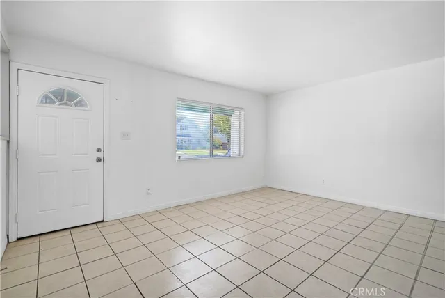 a view of a livingroom with wooden floor and a ceiling fan