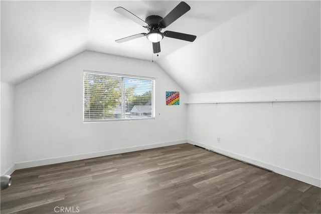 a view of a room with wooden floor and windows