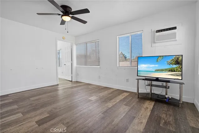 a view of room with workspace and wooden floor