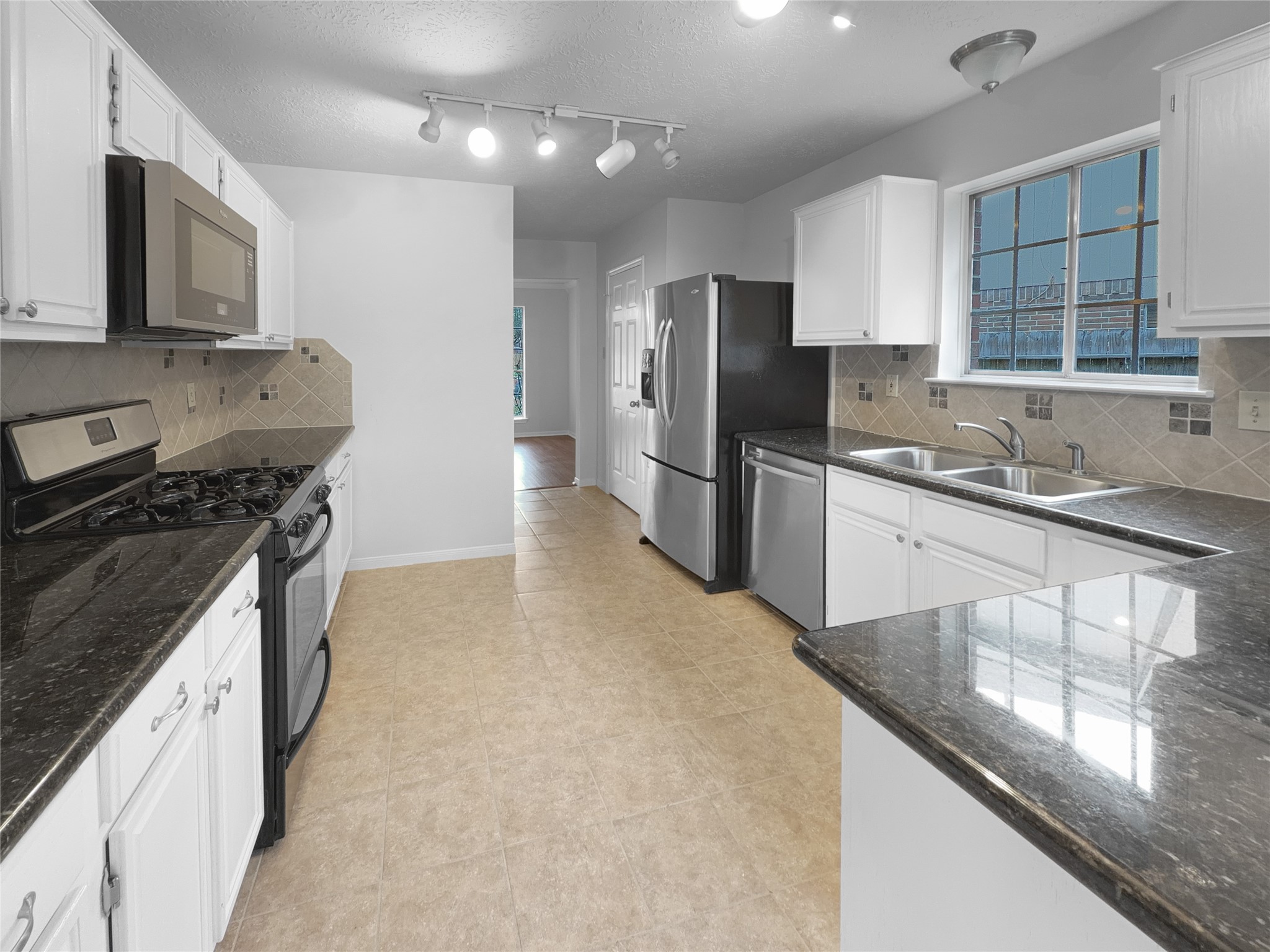 2130 Medway Drive Spring, TX 77386 - Photo 11 of 21 a kitchen with stainless steel appliances granite countertop a sink stove and refrigerator