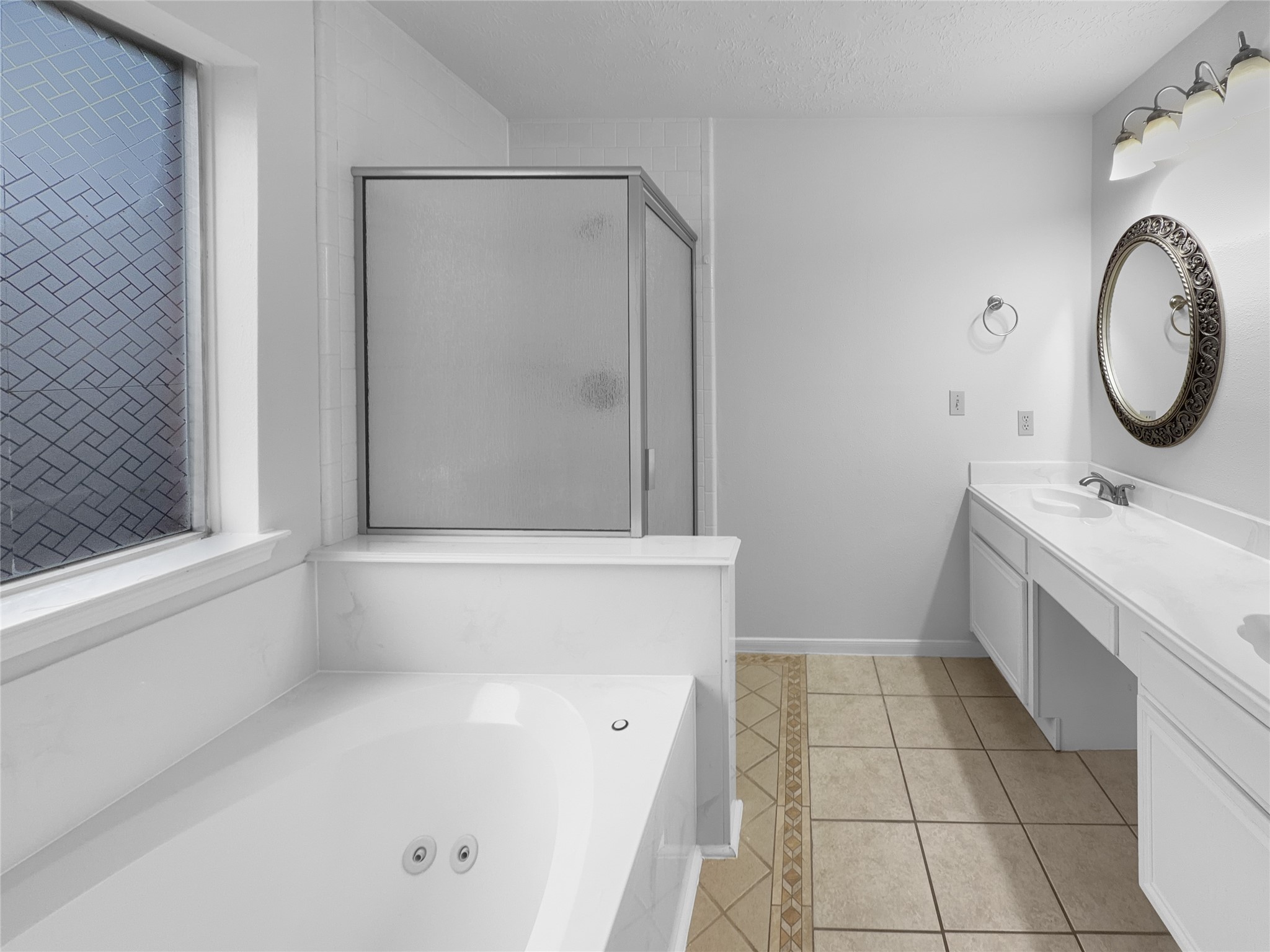 2130 Medway Drive Spring, TX 77386 - Photo 14 of 21 a bathroom with a bathtub a sink a vanity and a shower