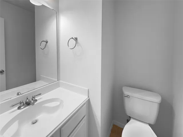 a white toilet sitting next to a bathroom sink