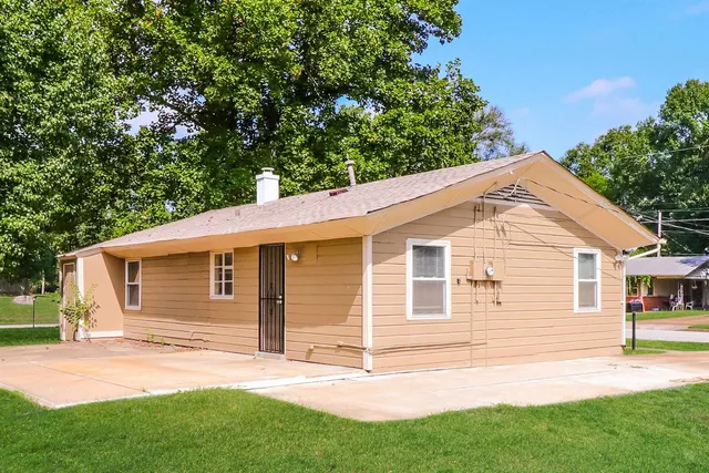 a view of a backyard with a garden and deck
