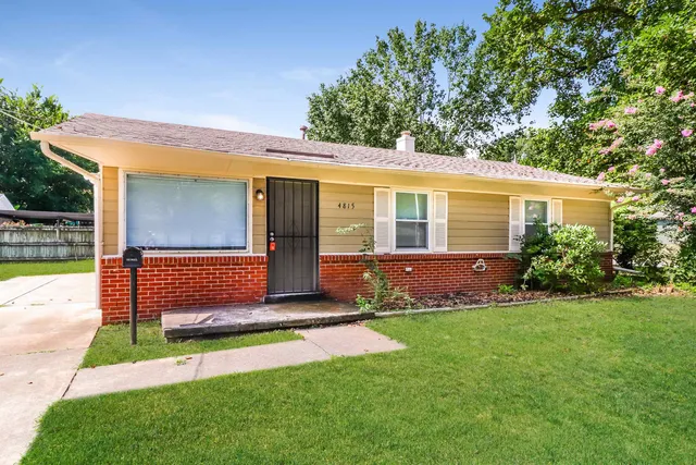 a front view of a house with a yard and porch