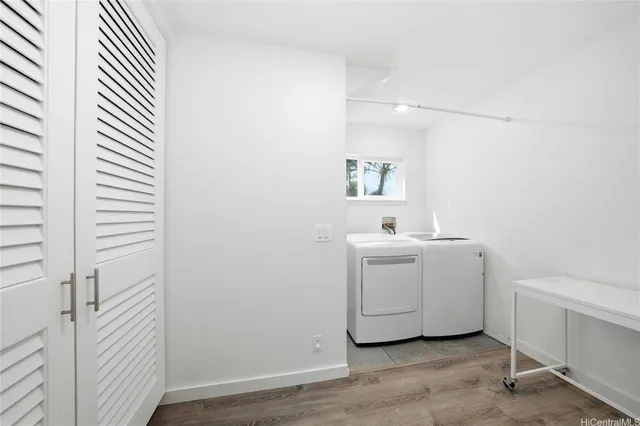 a utility room with cabinets washer and dryer