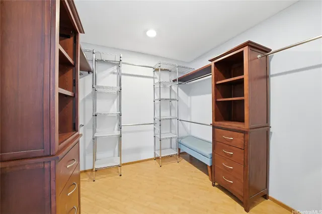a view of walk in closet with empty racks