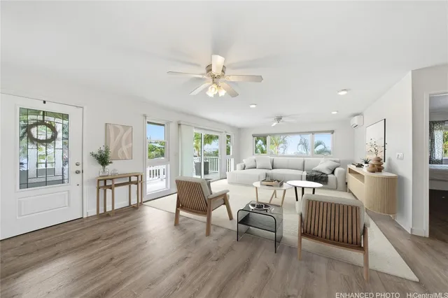 a living room with furniture and wooden floor