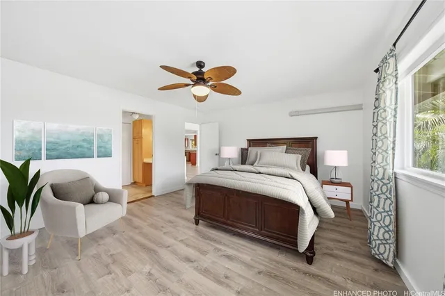 a bedroom with a bed and a large window