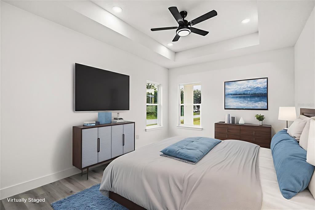 2798 Gainesville Road Southeast Palm Bay, FL 32909 - Photo 11 of 35 a bedroom with a bed and a flat screen tv