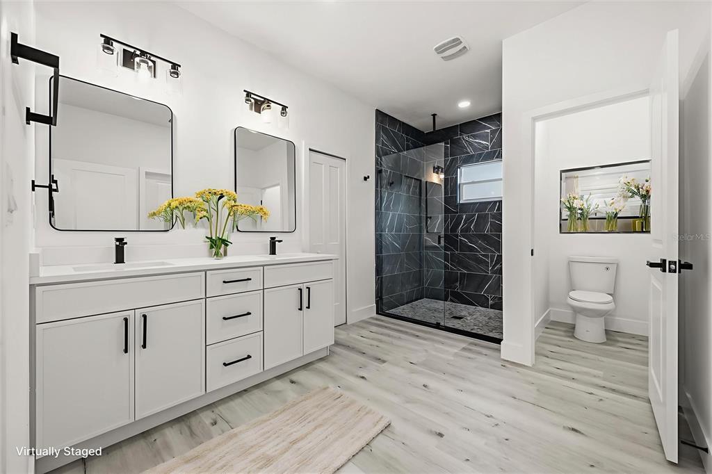 2798 Gainesville Road Southeast Palm Bay, FL 32909 - Photo 12 of 35 a spacious bathroom with double sink and shower