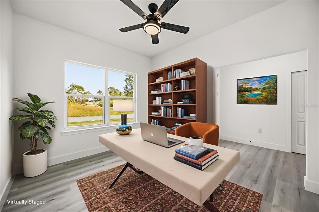 2798 Gainesville Road Southeast Palm Bay, FL 32909 - Photo 14 of 35 a workspace with furniture and a potted plant