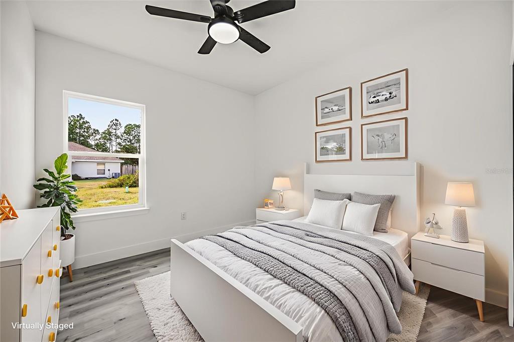 2798 Gainesville Road Southeast Palm Bay, FL 32909 - Photo 16 of 35 a bedroom with a bed and a painting on the wall