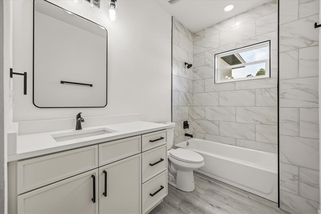 2798 Gainesville Road Southeast Palm Bay, FL 32909 - Photo 17 of 35 a bathroom with a sink toilet and shower
