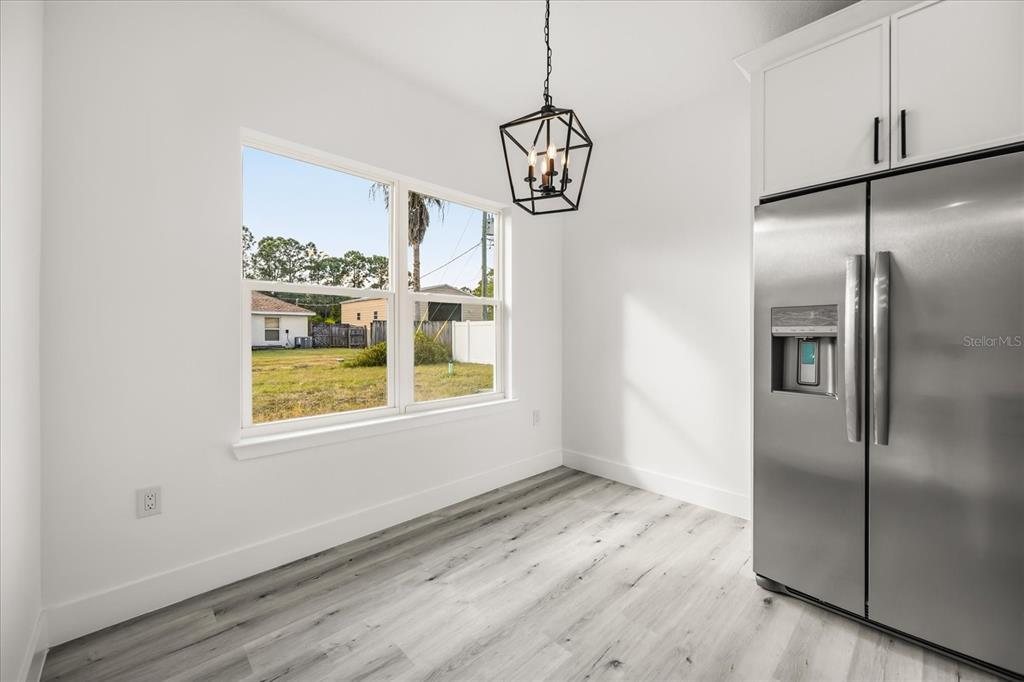 2798 Gainesville Road Southeast Palm Bay, FL 32909 - Photo 18 of 35 a view of an empty room with wooden floor and a window