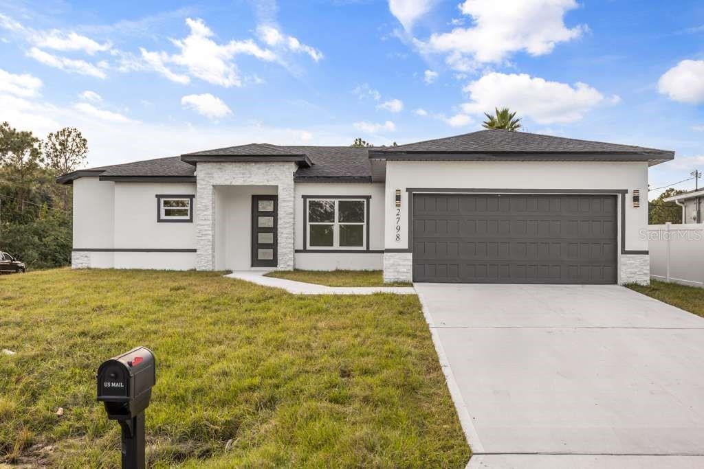 2798 Gainesville Road Southeast Palm Bay, FL 32909 - Photo 2 of 35 a front view of a house with yard